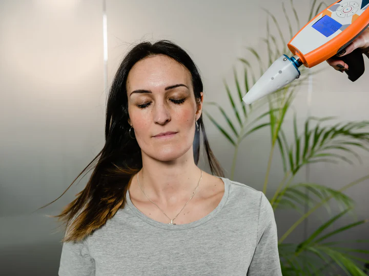 Adult receiving focused cryotherapy near her face